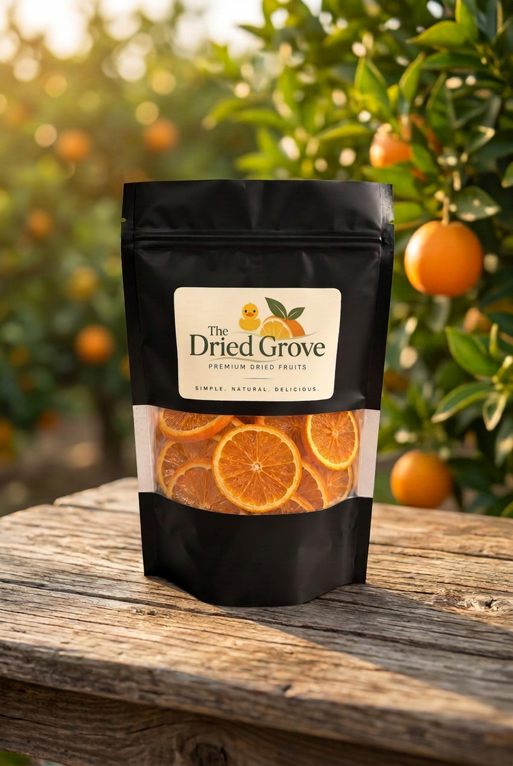 A Dried Grove pouch of dried orange slices on a wooden table in a citrus orchard